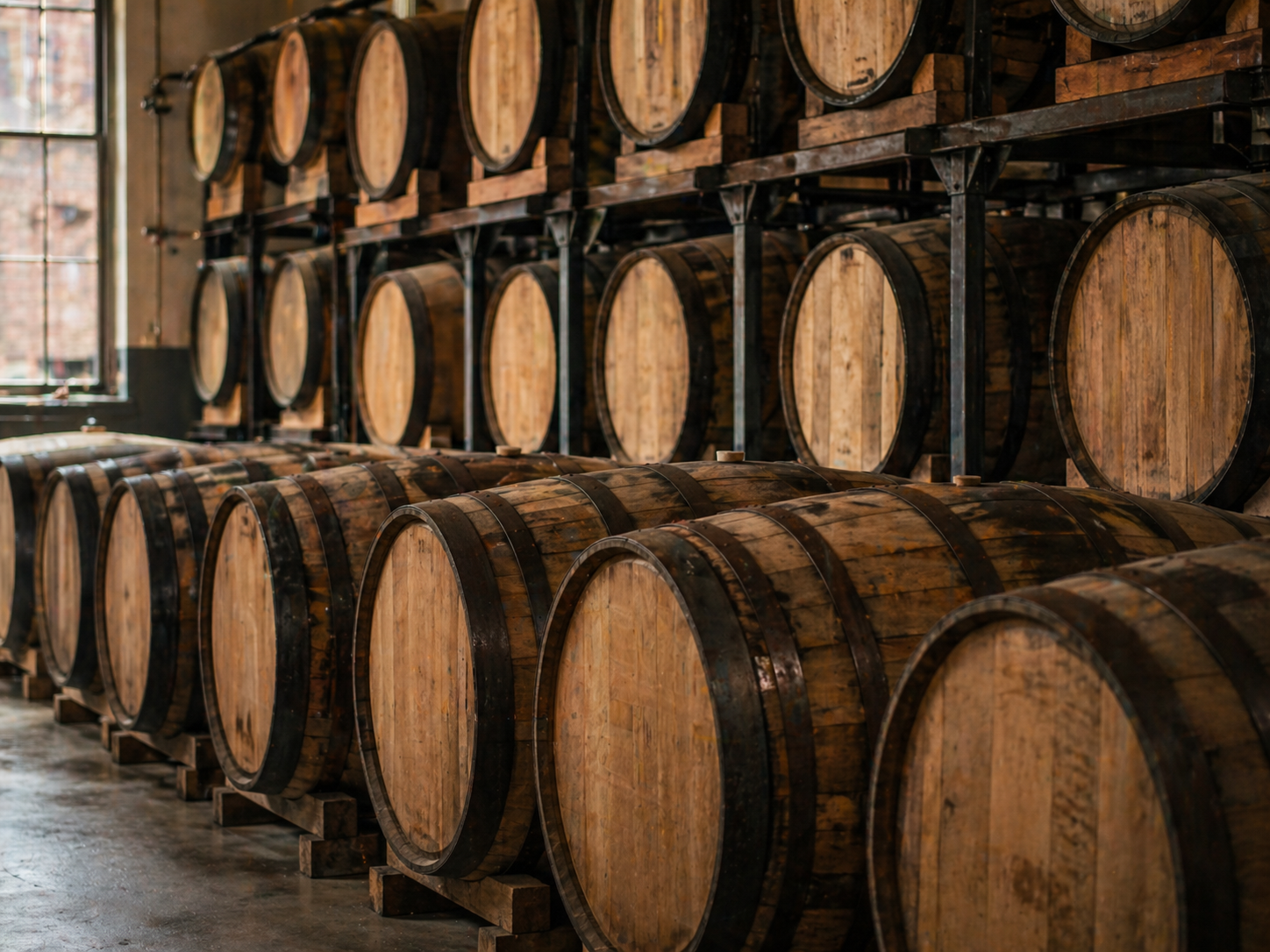 Oak barrels stored in a craft distillery warehouse